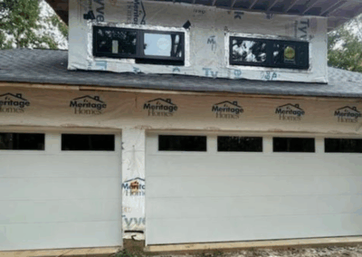 three car single attached grooved panel garage